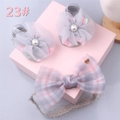 Detail of grey baby socks with mesh flowers and pink plaid bow headband in gift box - Style 23 (Grey Mesh Flower/Pink Purple Plaid)