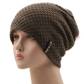 Detail of coffee brown waffle knit beanie with Realm fabric label on a white background - One Size / Khaki