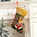 Christmas stocking with reindeer doll and green plaid fabric hanging on white fireplace - Medium Plush Reindeer Style