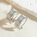 Silver striped texture earrings with a minimalist metallic finish on white stone - Striped Silver