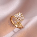 Elegant rotating four-leaf flower gold ring with sparkling cubic zirconia on champagne silk - Gold Ring / Gold