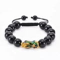 Detail of Pixiu obsidian bracelet with colorful enamel charm and adjustable cord - 12mm Black Glass Bead Bracelet