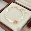 Elegant pearl bracelet featuring a pink gemstone centerpiece with gold accents and crystals - 65# Bracelet - White - Gold Plated