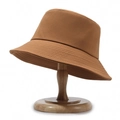 Minimalist caramel cotton fisherman hat displayed on a wooden stand with soft lighting - One Size / Yellow Brown