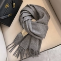 Dark gray Australian wool scarf with long fringe displayed on a beige leather chair - Dark Gray