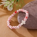 Handmade beaded bracelet with red-spotted white beads and a white cross pendant - White Red Spotted White Cross Bracelet