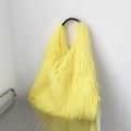Y2K fuzzy yellow faux fur tote bag with black handles on a metal grid display - Goose Yellow