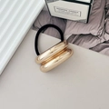 Black elastic hair tie featuring double thick polished gold metal rings in 45-degree view - Style F KC Gold