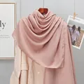 Detail of soft lotus pink linen scarf draped over a beige blazer in a stylish setting - Light Coffee
