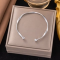 Elegant Mobius twisted stainless steel bangle with spherical ends in a luxury gift box - Silver Twisted Bead Open Bangle
