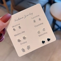 Detailed view of 6 pairs of silver earrings on a Monday to Saturday card set - E1587-1 Silver Star Crown Black Heart Style