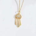 Detailed view of the gold-plated fringe pendant necklace with sparkling zircon accents - Geometric Tassel Style