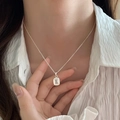 Silver thin chain necklace with a rectangular clear gemstone pendant on a female model - Rectangular Transparent Gem Style (XL2697)