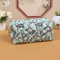 Quilted floral makeup bag in green with pink leaf prints and golden zipper closure - Garden Green