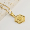 Polished gold stainless steel hexagon letter M pendant necklace on white stones - Letter M (Single Pendant)