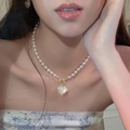 Detailed view of an elegant pearl necklace with a gold heart pendant and small crystals - Mermaid Heart Style (3#)