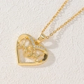 Macro shot of gold heart-shaped pendant necklace with MOM lettering and zircon accents - Heart MOM Hollow/Single Side Zirconia