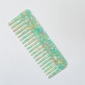 Detailed view of pale green marble-textured acetate hair comb with wide teeth design - Large (D#) / Green (D#)