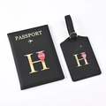 Close-up of black passport holder and luggage tag set with gold letter H and balloon - Black Letter H