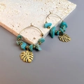 Detail of bohemian gold hoop earrings with turquoise stones and monstera leaf pendants - Leaf