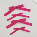 Detailed view of magenta satin bow hair clips in four sizes with metal backings - Rose Red (4pcs Set)