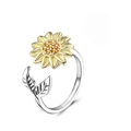 Adjustable silver spinner ring featuring a golden sunflower and green leaf accents - Leaf Sunflower Rotating