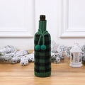 Knitted green and black checkered wine bottle cover with decorative double pom-poms - Black and Green Grid