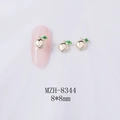 Detail view of 8x8mm alloy peach nail charms with green leaves on pink manicure - Light Gold Peach (Gold Base) (8344)