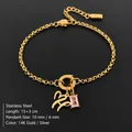 14K gold plated stainless steel bracelet featuring letter pendant and pink gemstone charm - Letter H