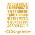 Close-up of DIY orange alphabet and number stickers for journals and gift decorating - Orange