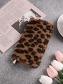 Plush leopard print pouch with gold zipper closure on a stylish textured desk background - Brown