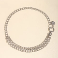 Silver metal chain belt with round charm and ring buckle on beige textured background - Silver