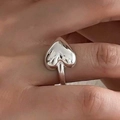 Minimalist silver puffed heart ring with high polish finish shown worn on finger - Silver Horizontal Heart Ring