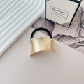Elastic hair tie with a textured gold curved metal piece and high-stretch black cord - Style P KC Gold
