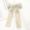 Detailed shot of handmade pearl beaded bow hairpin with elegant silver sequin patterns - White Beaded Bow Clip