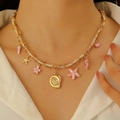 Detail of colorful woven rope necklace with starfish, seahorse and seashell charms - KC Gold Pink (8343)