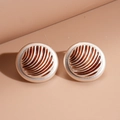 Detailed view of vintage round stud earrings with caramel enamel and golden radial texture - Silver