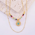 Detail of bohemian double-layer necklace with colorful beads and golden sun pendant - Turquoise Sunflower