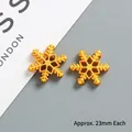 Detailed view of 23mm golden snowflake charms with hollow hexagonal design for DIY crafts - Medium (approx 23mm) / Gold