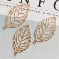 Close-up of golden hollow leaf charms with detailed veins for DIY jewelry making - Hollow Leaf