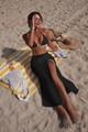 Close-up of black bikini set with gold ring detail and high-slit beach skirt - S / Three-Piece Set / Black