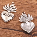 Silver Halloween heart pendants with flame texture on a wooden background - 27B2-11 Flame Sacred Heart