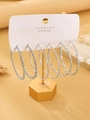 Three pairs of silver hoop earrings in twisted and smooth textures on a jewelry card - Silver White (2444)