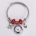 Close-up of adjustable steel wire bracelet with swan pendant and red beads with quartz watch - Red