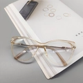Cat eye glasses featuring translucent champagne frames and elegant gold metal temples - Champagne
