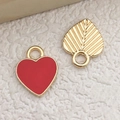 Golden heart pendant with red enamel and detailed leaf charm on white plush background - Large Red Heart Pendant 10x12mm (11027)