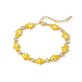 Detail of gold Hamsa Hand bracelet with yellow enamel pendants and clear cubic zirconia - Yellow