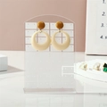 Mustard yellow and creamy white geometric resin earrings on a clear acrylic display stand - Transparent + White Grid