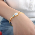 Golden titanium steel bangle featuring white shell inlay and green turquoise round charms - Gold Color (Z293)