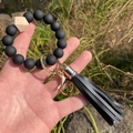 Detail of black silicone beads and hexagonal wood bead wristlet with leather tassel - Black